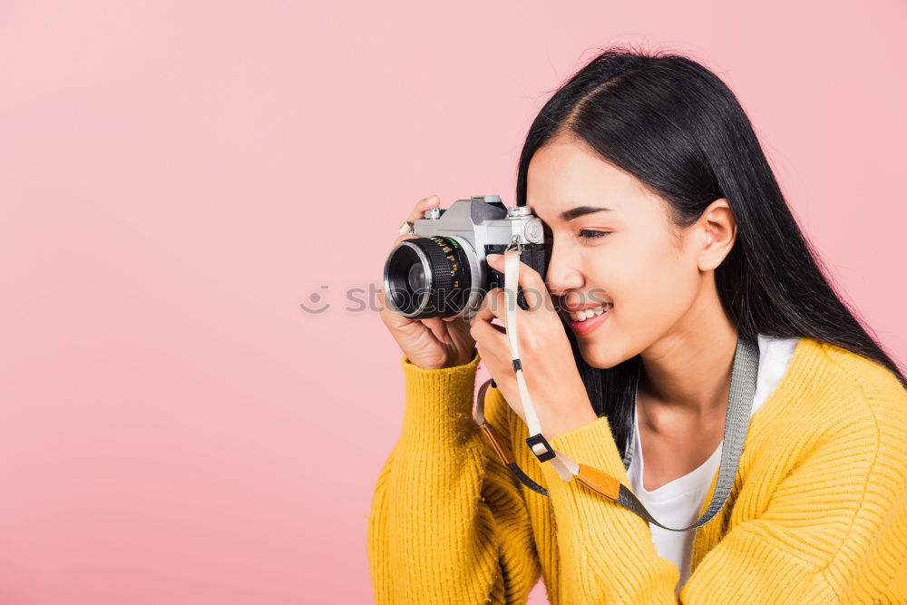 Similar – close up portrait of a young woman holding a camera. Photography concept