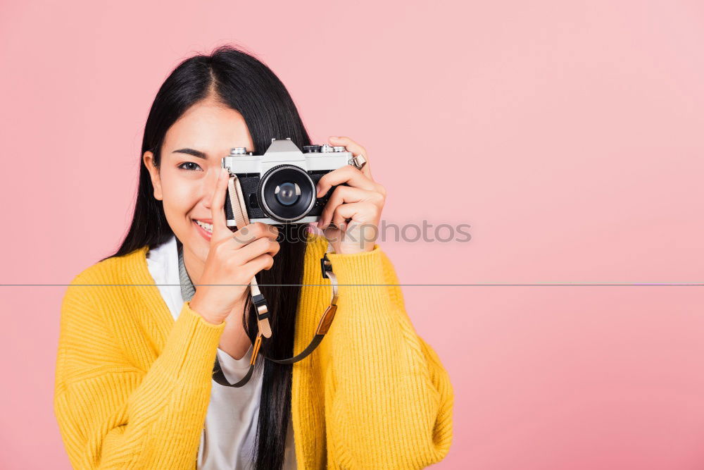 Similar – close up portrait of a young woman holding a camera. Photography concept