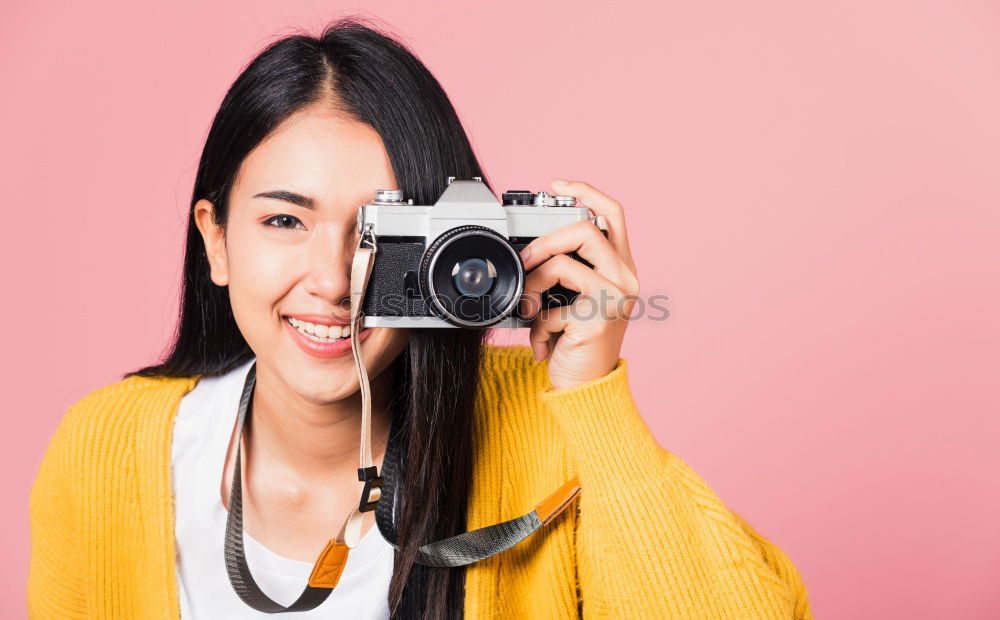 Similar – close up portrait of a young woman holding a camera. Photography concept