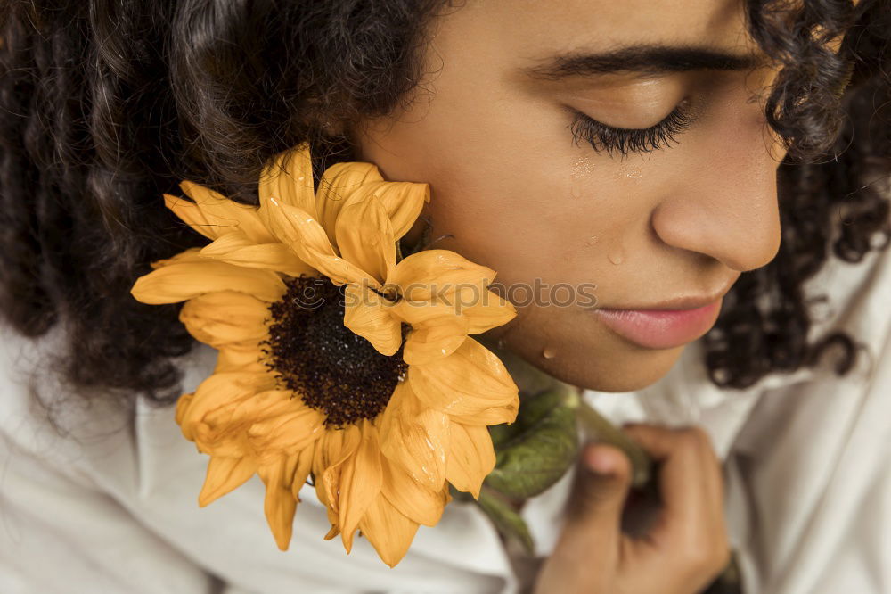 Similar – young african american woman in yellow dress enjoying a garden with yellow flowers