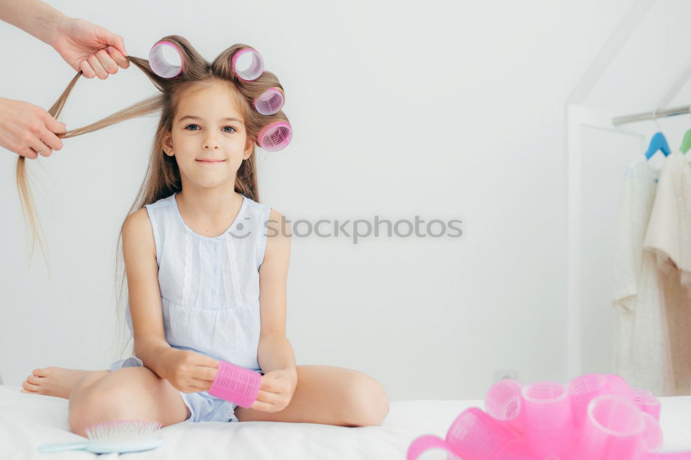 Similar – mother brushing toddler daughter’s hair