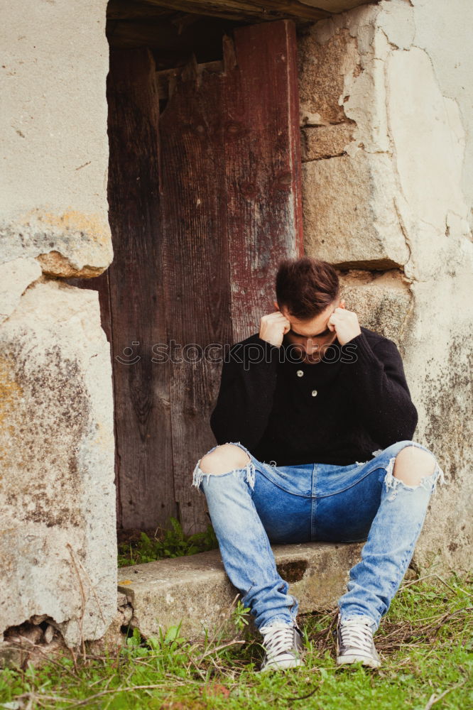 Similar – Young man sitting on the floor in urban background