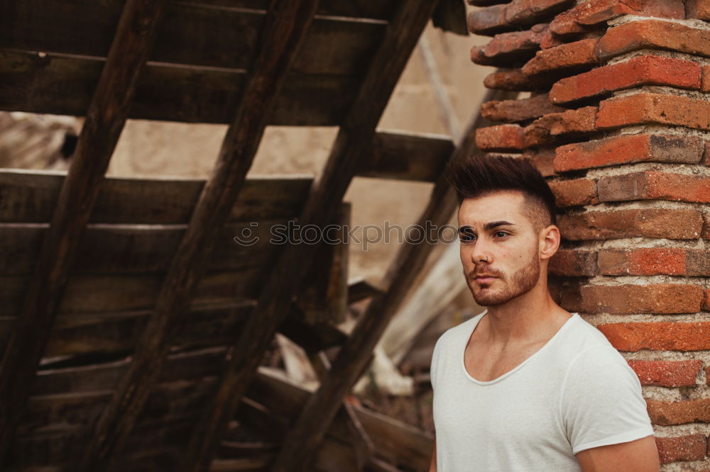 Similar – Image, Stock Photo Young handsome man over a dark brick wall