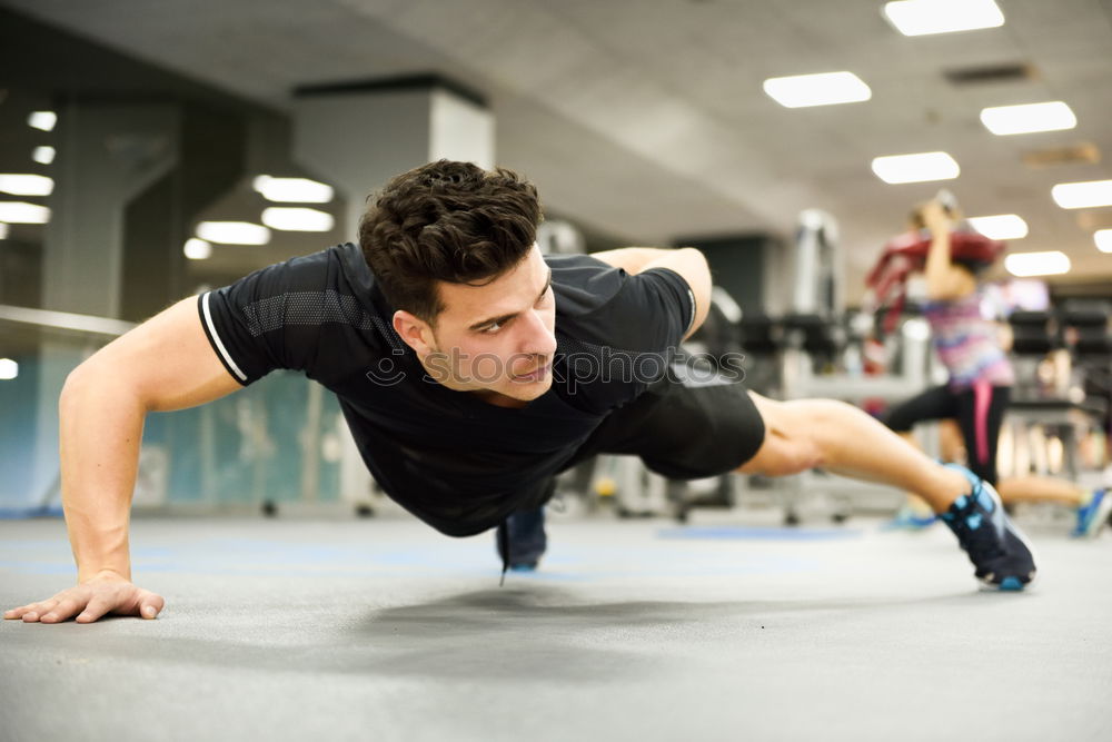 Similar – Attractive man doing pushups in the gym.