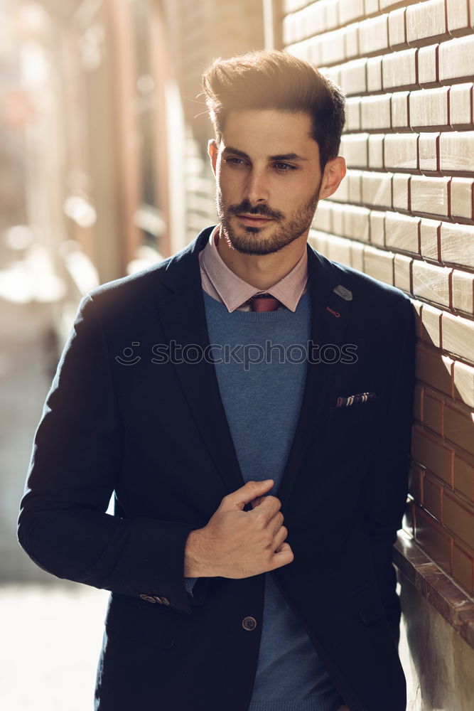 Attractive man in the street wearing british elegant suit