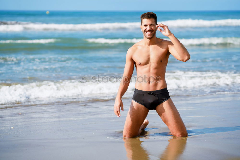 Similar – Handsome muscular man bathing on the beach