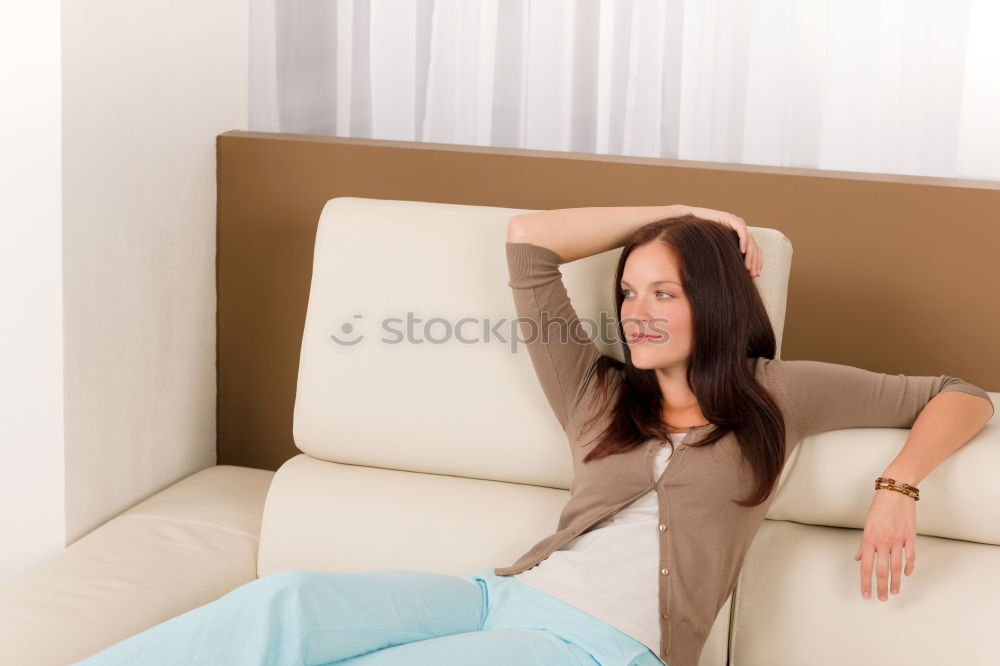 Similar – young tall woman sits on a light couch