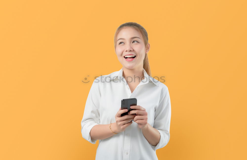 Similar – Portrait of beautiful young woman using mobile phone in the street.