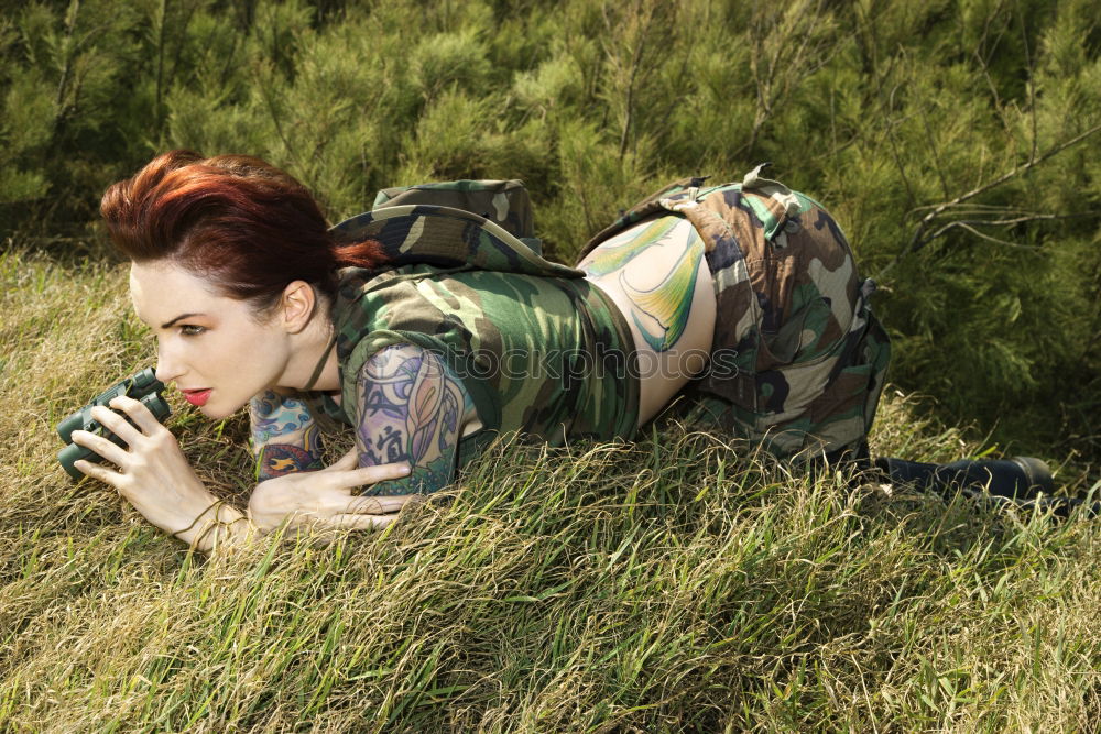 Similar – Young woman with turquoise hair sits barefoot in beach forest leaning against tree and looks skeptically at camera