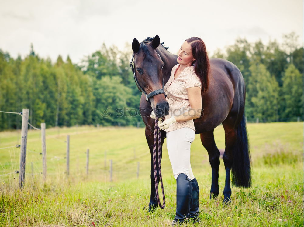 Image, Stock Photo Beautiful young rider woman with horse in nature. Love and friendship between man and animal. Portrait in landscape near horse stable of riding farm with riding school or farm with pet for hobby riding.