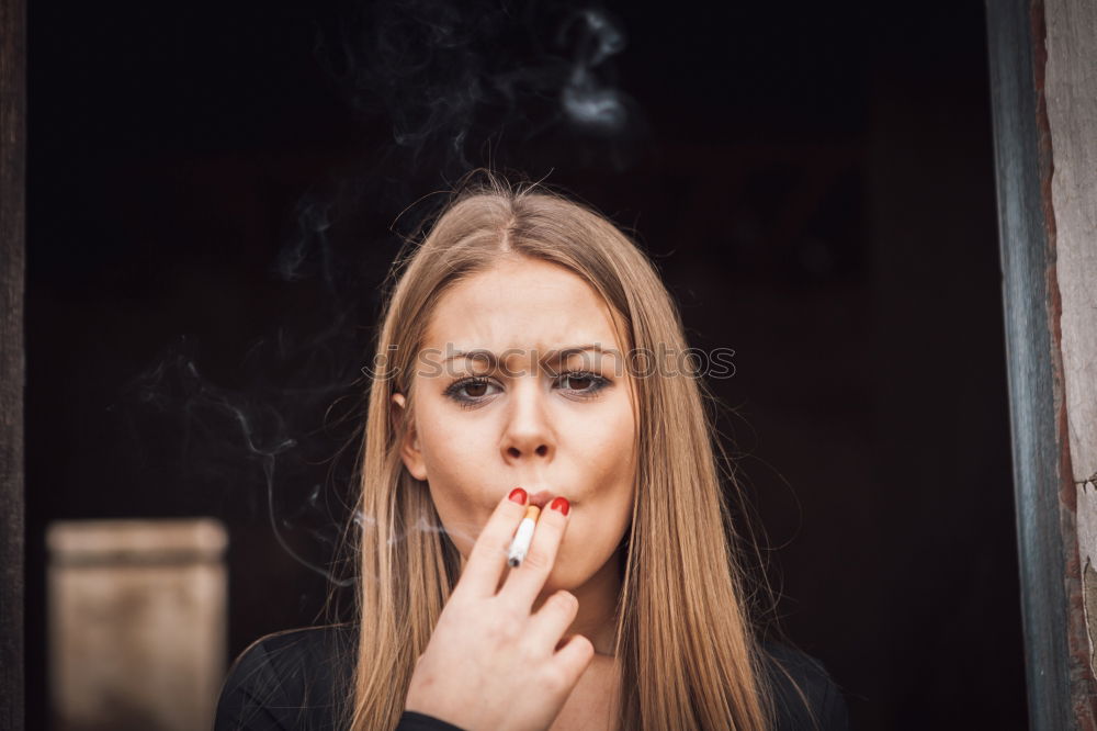 Similar – Young girl sitting on the floor and smoke