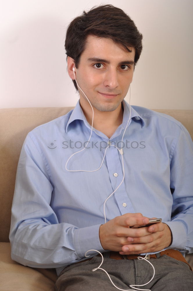 Similar – Relaxed boy holding smartphone sitting in chair at home