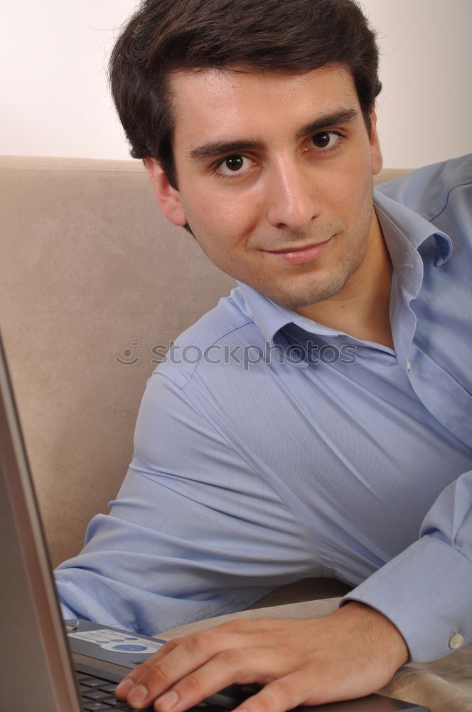 Similar – Relaxed boy holding smartphone sitting in chair at home