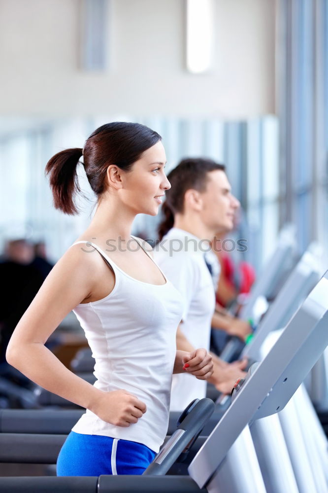 Similar – Woman drinking water while training on treadmill