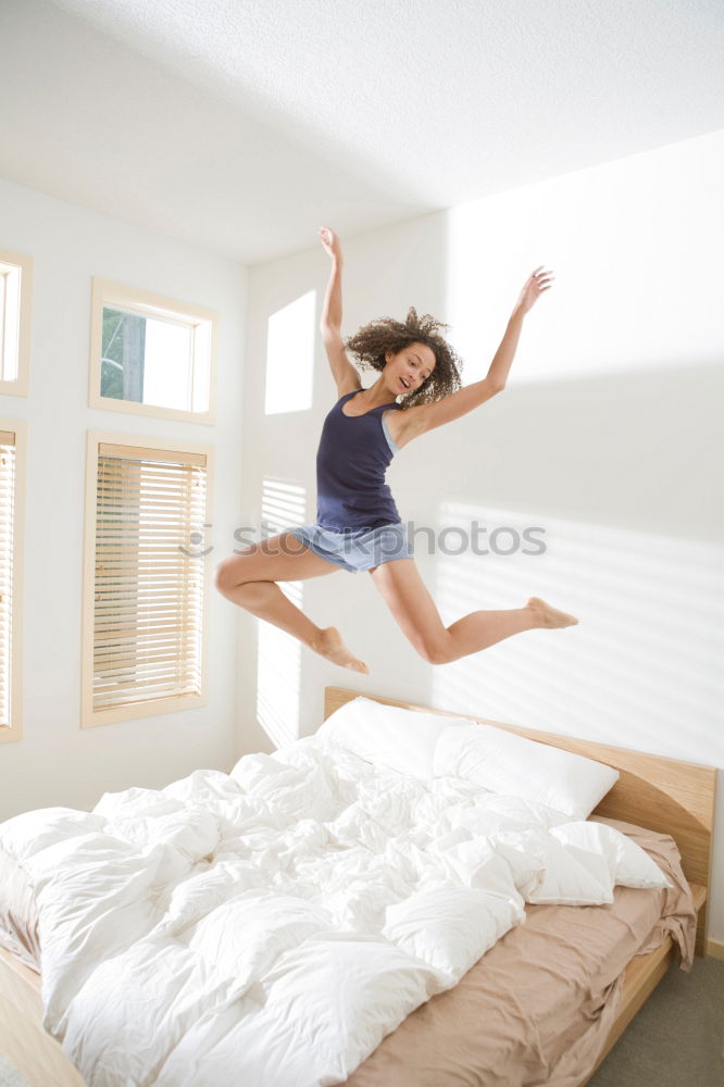 Similar – Long haired girl in jeans jumps headfirst into a sofa