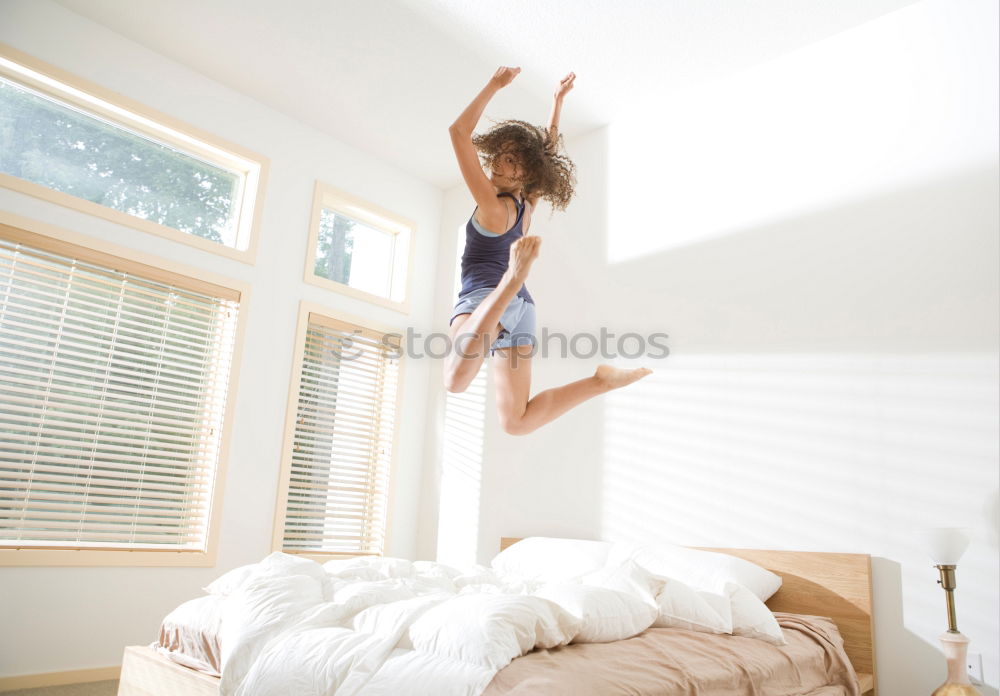 Similar – Long haired girl in jeans jumps headfirst into a sofa