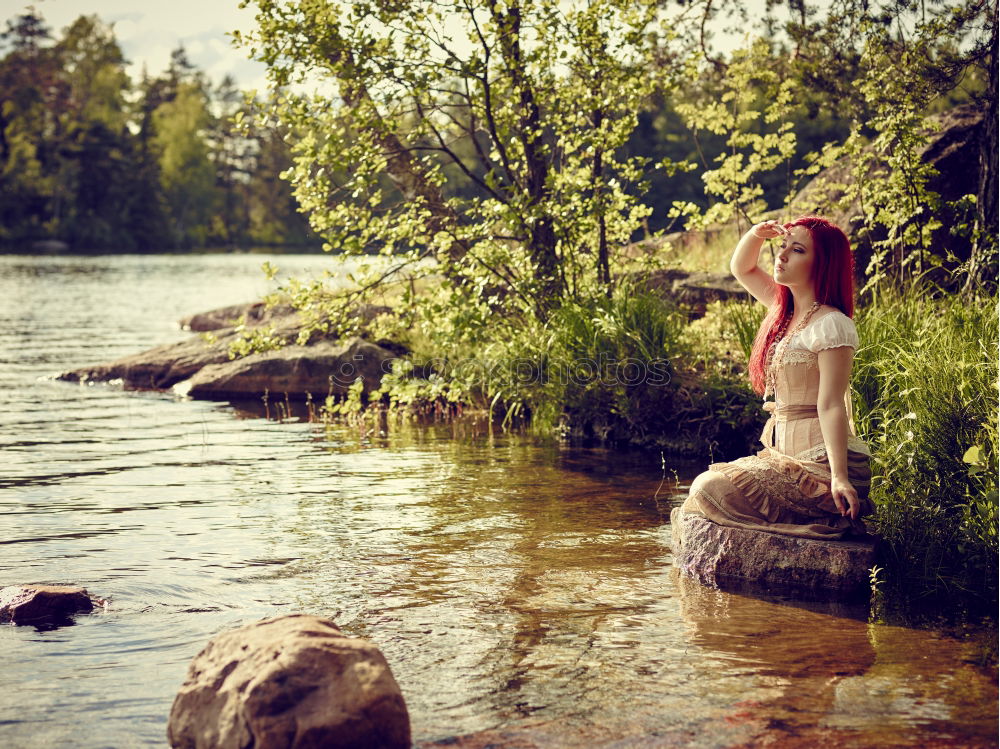 Similar – Image, Stock Photo analog medium format portrait of young woman in summer dress sitting barefoot among bushes in nature on a lakeside