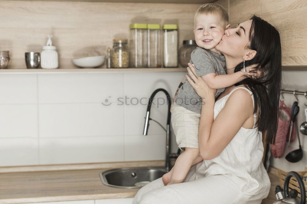 Mother and son baking together in kitchen