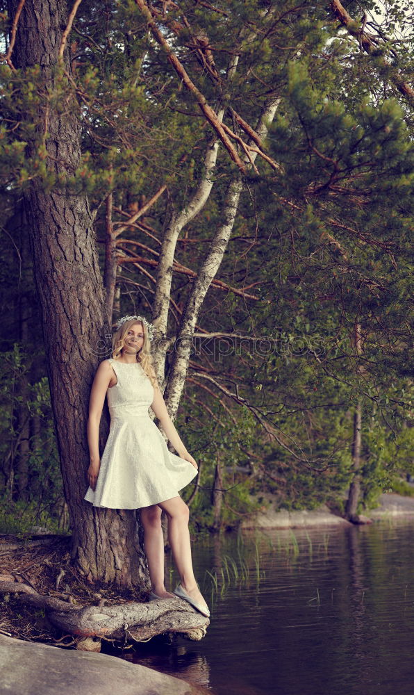 Similar – Young woman on a tree trunk in the forest