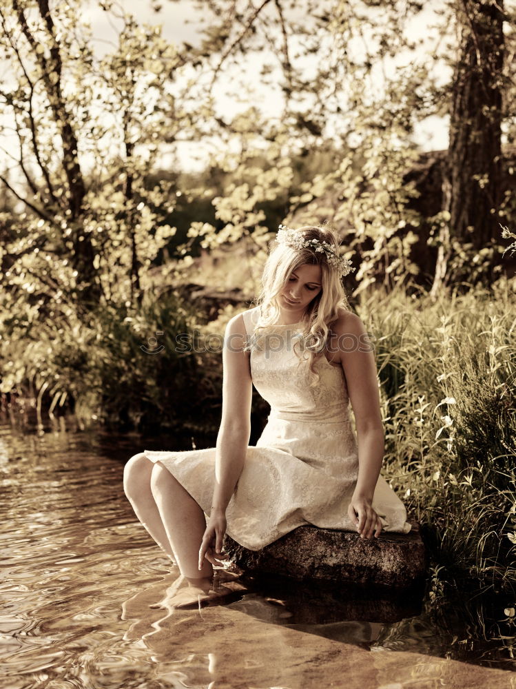 Similar – Young woman with turquoise hair sits barefoot in forest on beach and laughs loudly