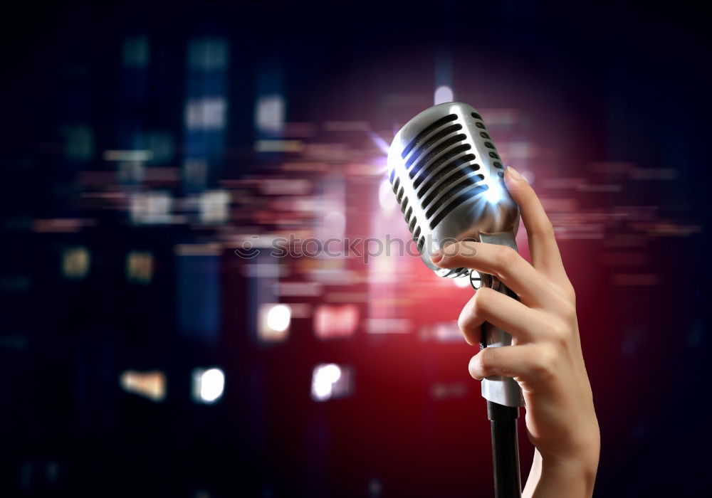 Similar – Woman holding microphone with two hands over black