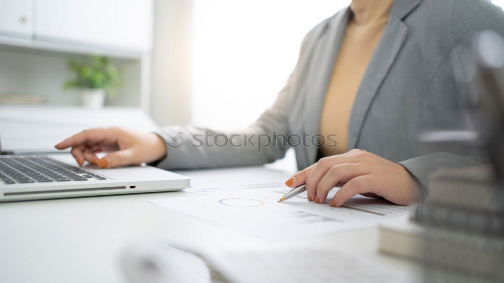 Young man works on a laptop in the start-up and listens to music through in-ear headphones