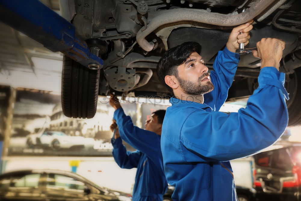 Similar – Professional Mechanic Repairing Car.