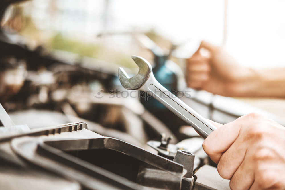 Similar – Man putting part on bike