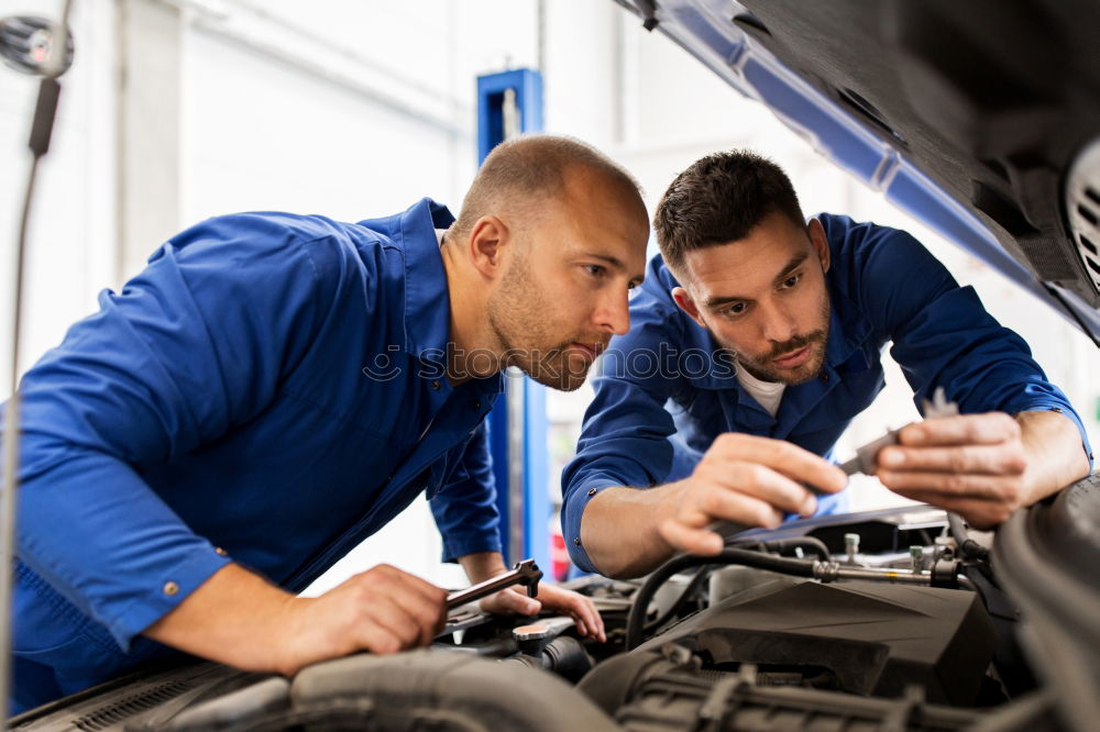 Similar – Professional Mechanic Repairing Car.