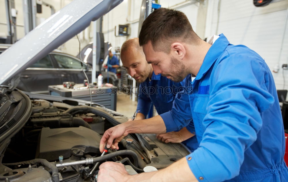 Similar – Professional Mechanic Repairing Car.