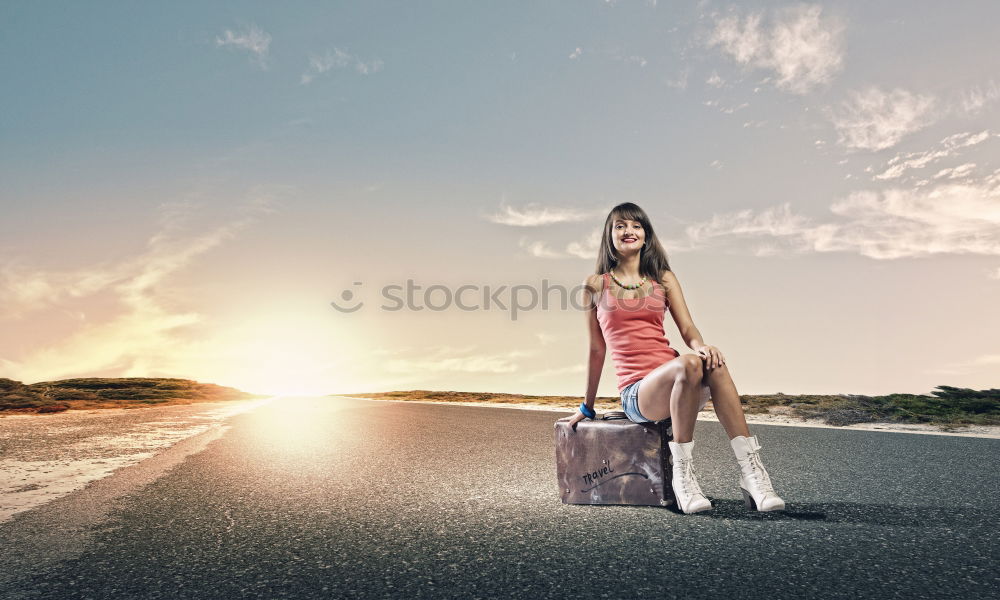 Boy with suitcase on the road