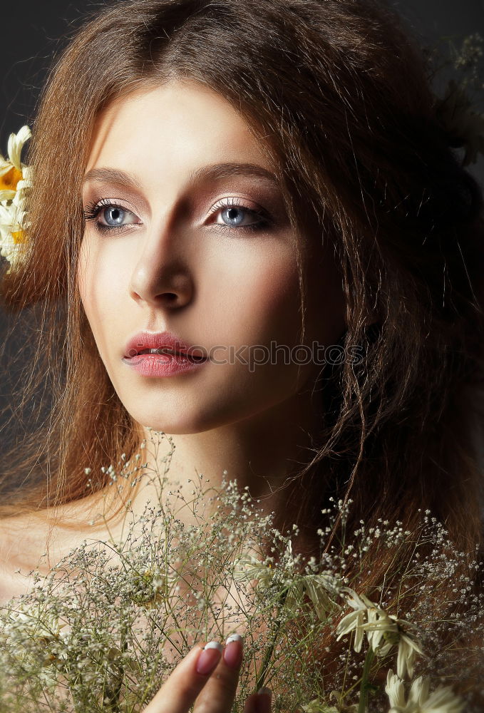 Pretty woman standing with white flowers