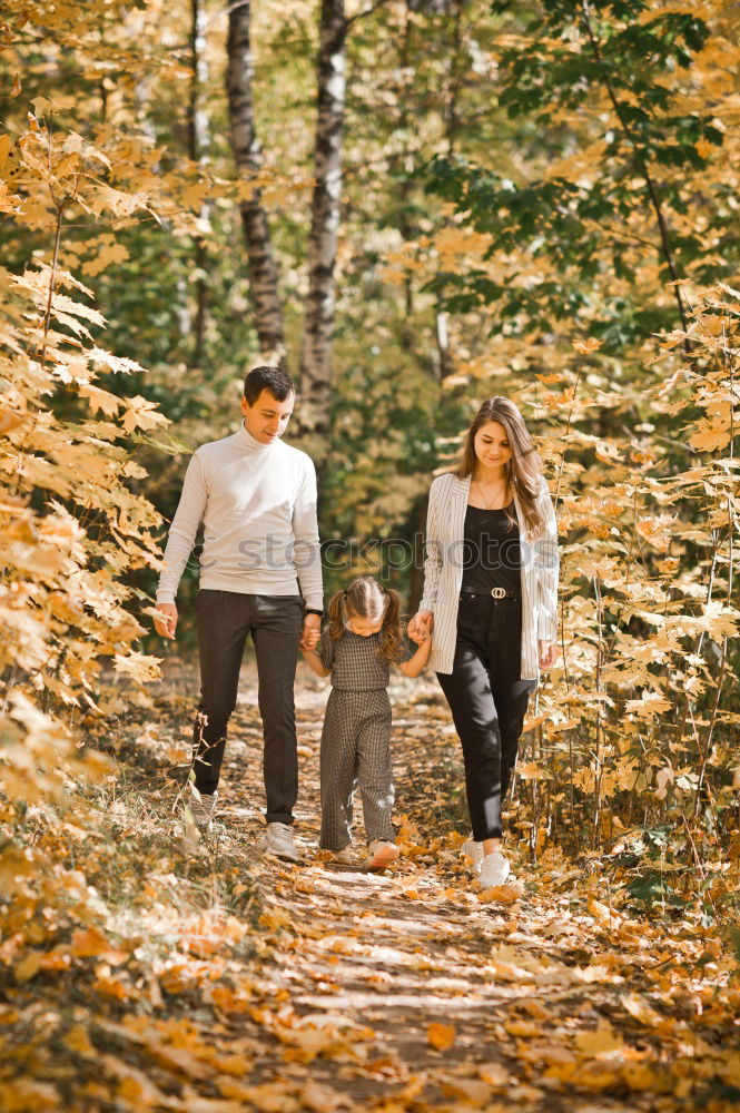 Similar – Happy family walking together holding hands in the forest