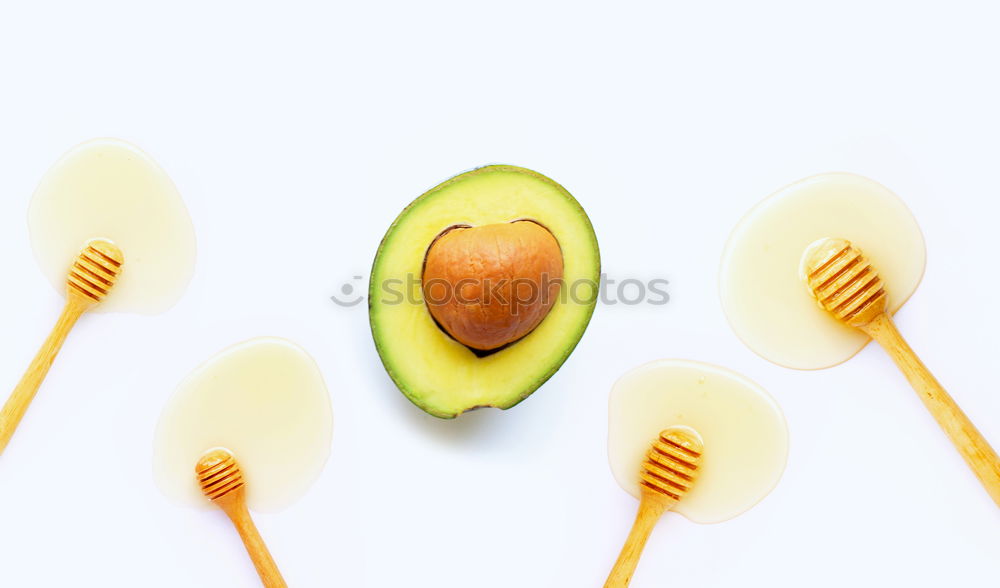 Similar – Cut avocado on white plate on pastel background