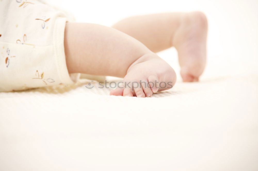 Similar – Cute Baby Girl Lying in the Baby Changer.