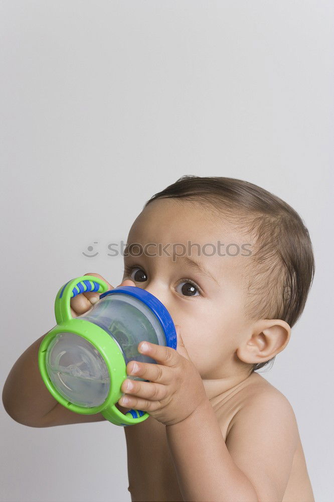 Similar – Image, Stock Photo Baby sucks on a bottle.