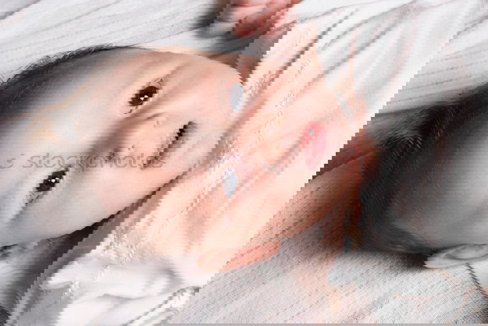 Similar – Image, Stock Photo mom dresses the baby on the bed