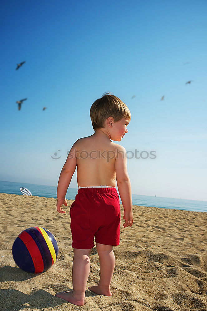 Similar – little girl stands on beach in a special swimsuit for children who can not swim. child in swimsuit, which he kept afloat