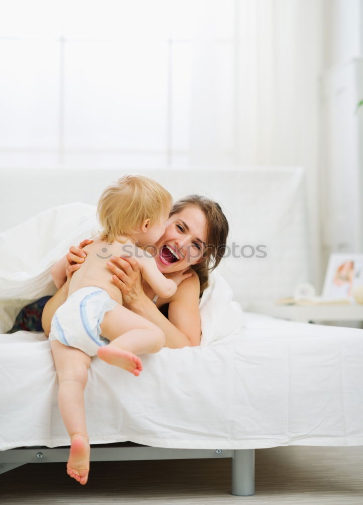 Two beautiful sisters playing on bed