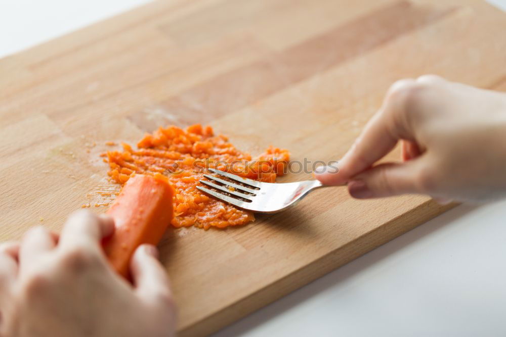 Similar – process of slicing carrots on slices on a kitchen board