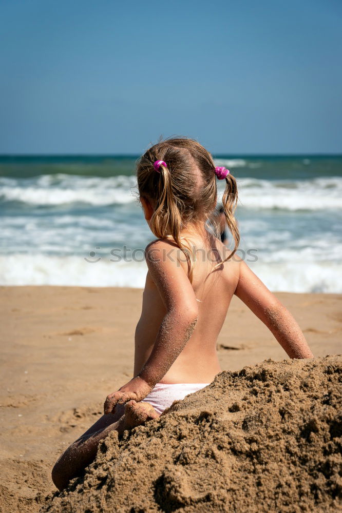 Similar – Image, Stock Photo Mother throwing sunscreen on her little daughter on a tropical beach
