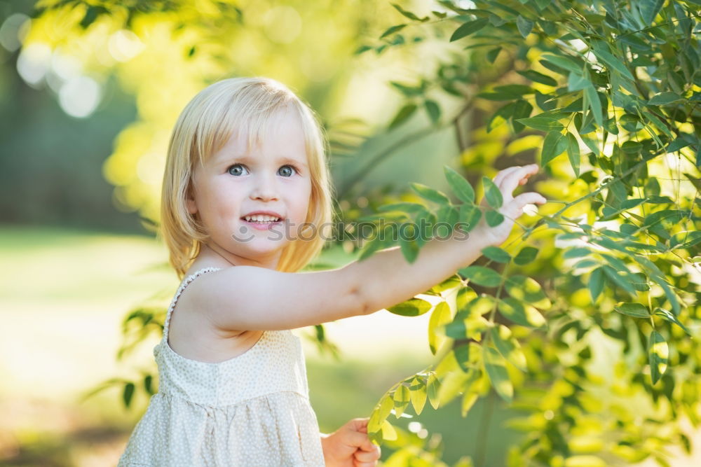 Image, Stock Photo Little baby is touching fresh spring leaves in her mother’s hug