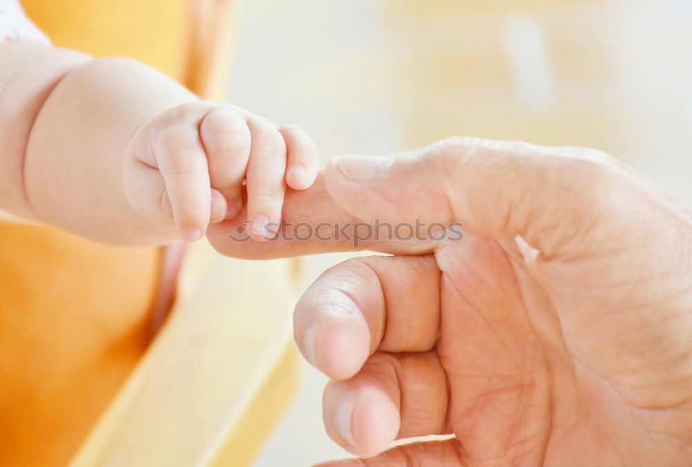 Similar – Baby girl sitting over legs of senior man outdoors