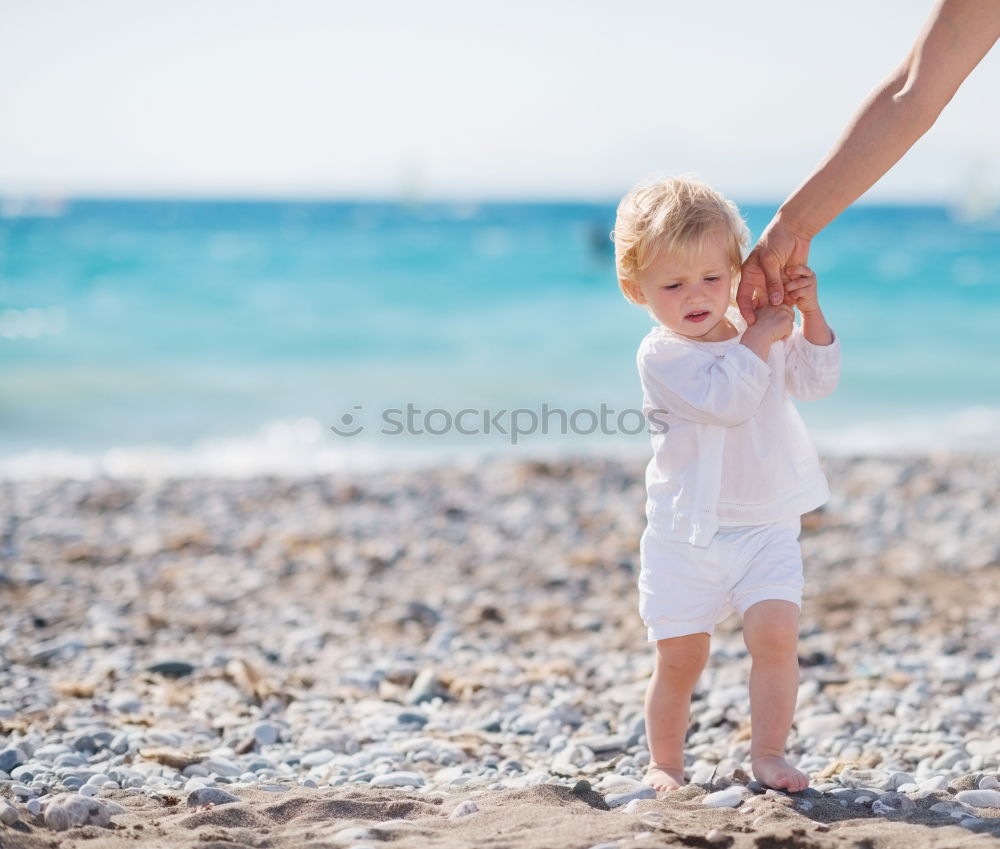 Similar – mother and son having fun with inflatable ring at beach