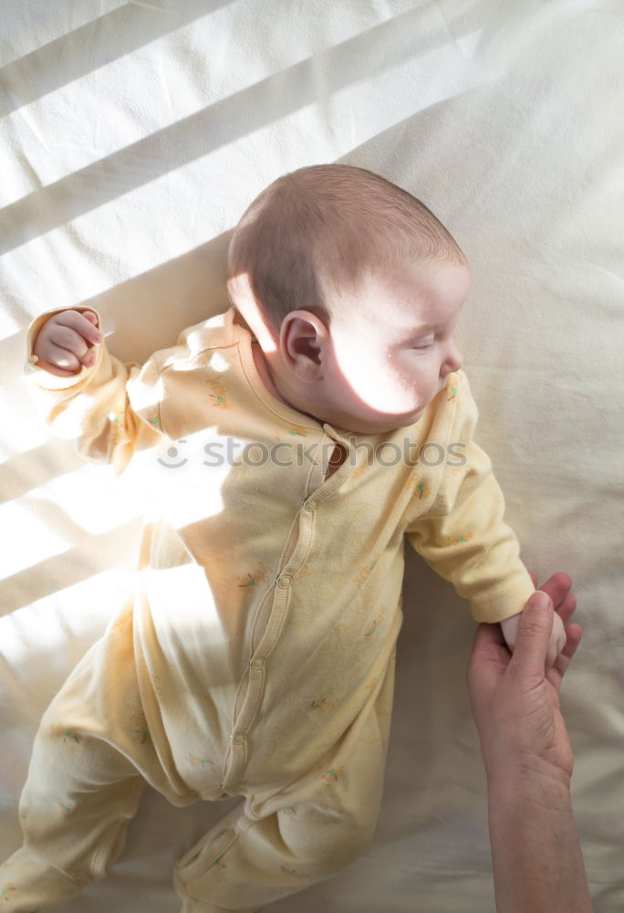 Similar – Person touching hand of baby