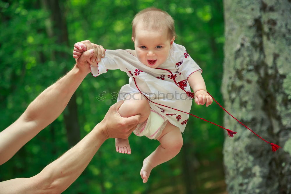 Similar – Image, Stock Photo Mother holding kid on hands in park