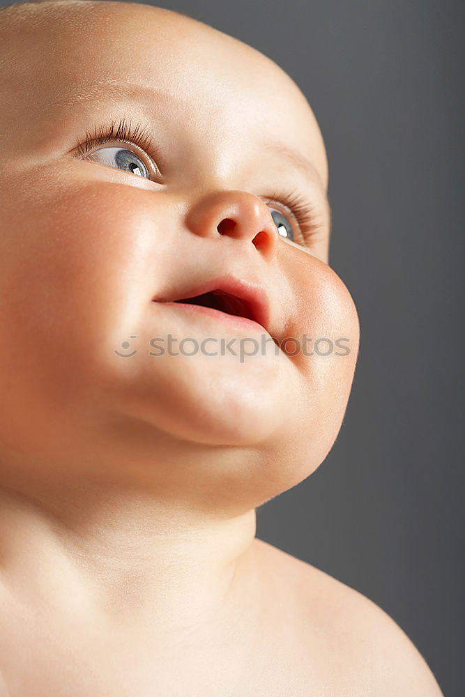 Similar – a happy baby boy sitting on a sofa and smilling