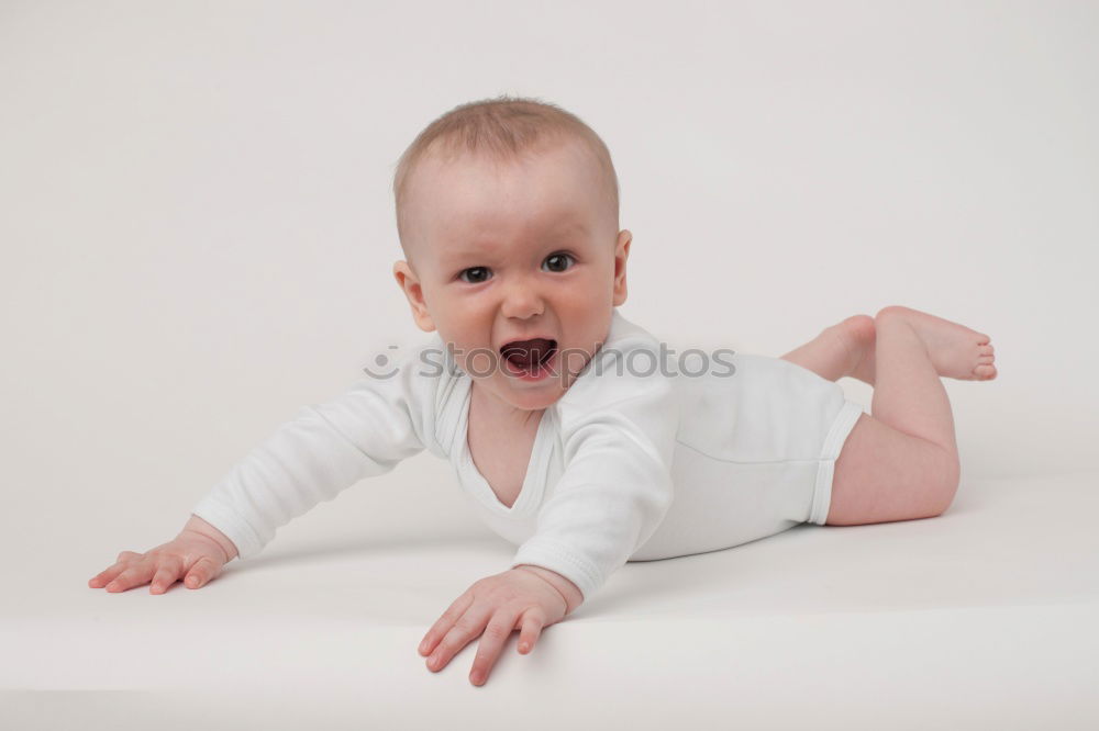 Similar – Happy baby girl, four months old, on the bed with pacifier.