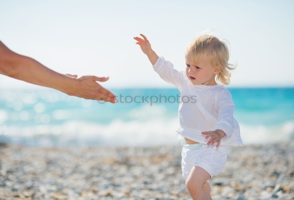 Similar – mother and son having fun with inflatable ring at beach