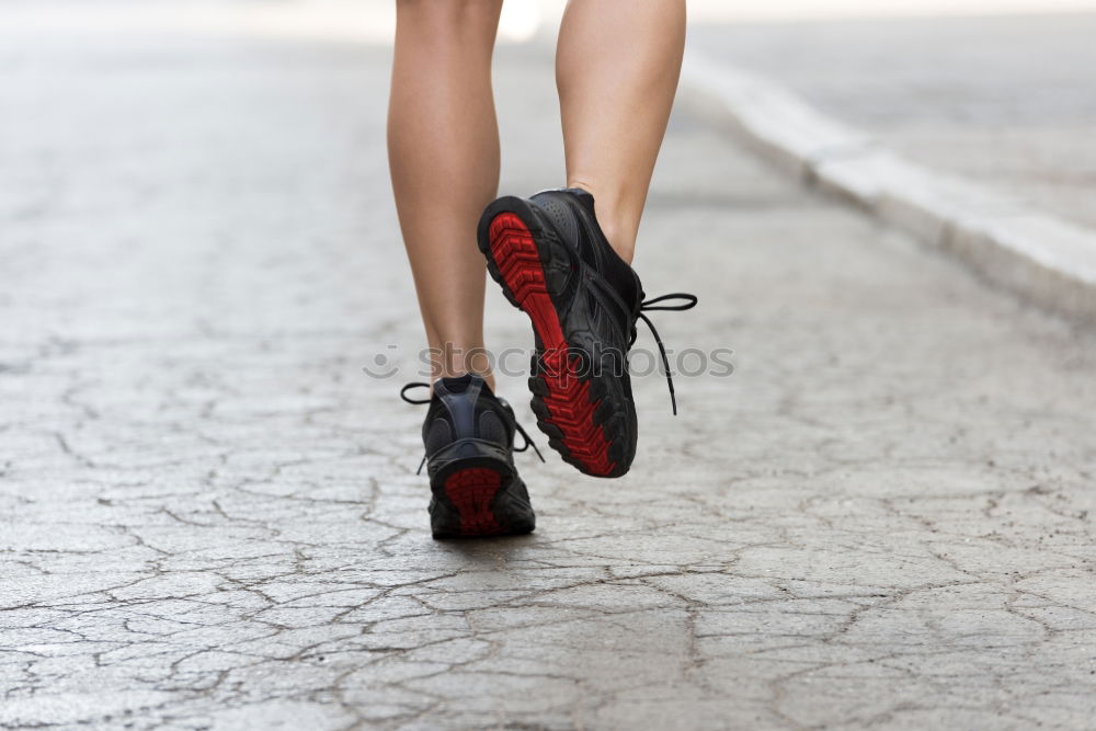 Similar – Young woman jogging down an autumn street